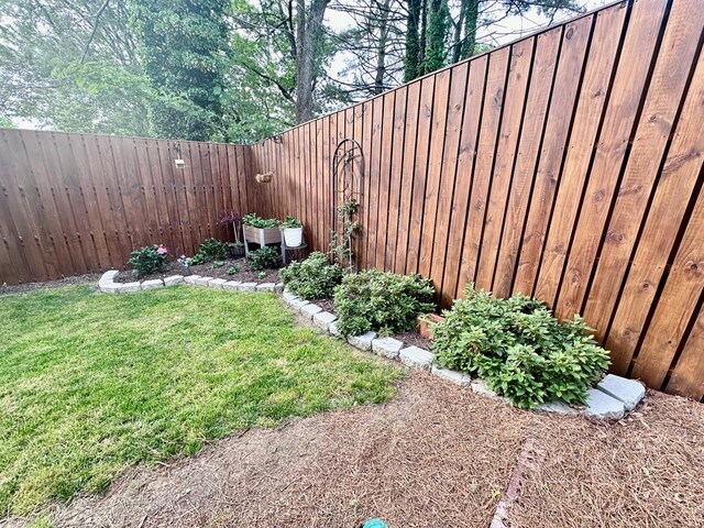 view of yard with a fenced backyard