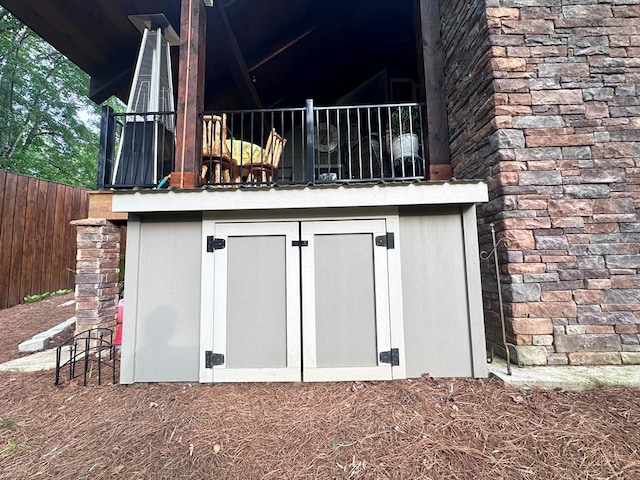 view of outbuilding featuring fence