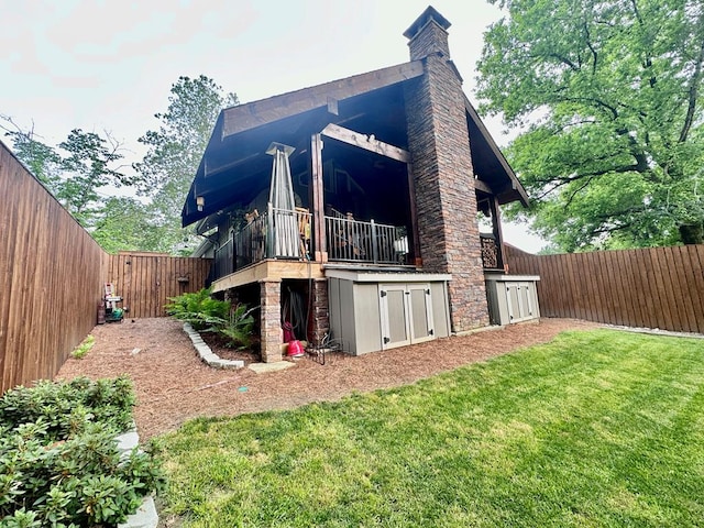 view of property exterior featuring a fenced backyard, a lawn, and a chimney