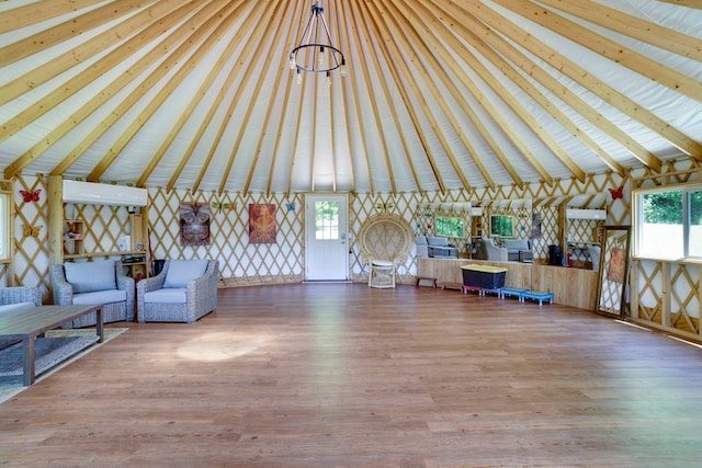 910 Sawyer Cove Rd, Hayesville, NC 28904 - unfurnished living room with beam ceiling, wood finished floors, and high vaulted ceiling