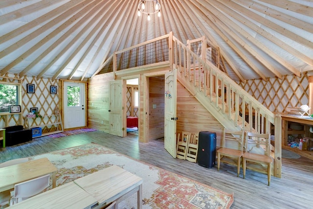 910 Sawyer Cove Rd, Hayesville, NC 28904 - unfurnished living room with lofted ceiling, wood finished floors, and wallpapered walls