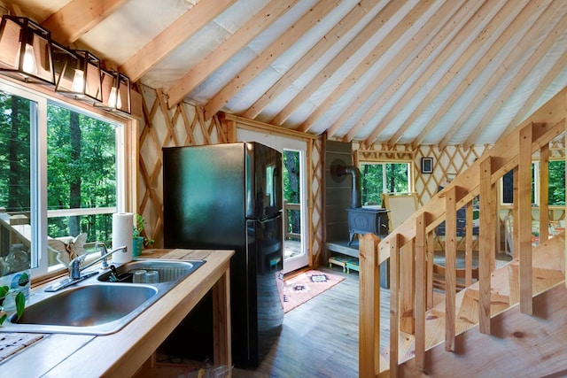 910 Sawyer Cove Rd, Hayesville, NC 28904 - kitchen with a wood stove, freestanding refrigerator, a sink, wood walls, and wood finished floors