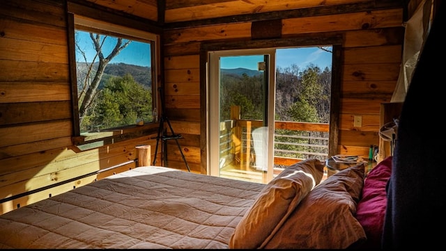 bedroom featuring a mountain view and wood walls