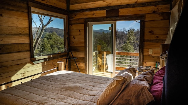 bedroom with a mountain view and wood walls