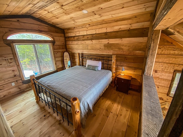 unfurnished bedroom featuring wood ceiling, lofted ceiling, wooden walls, and light wood-type flooring