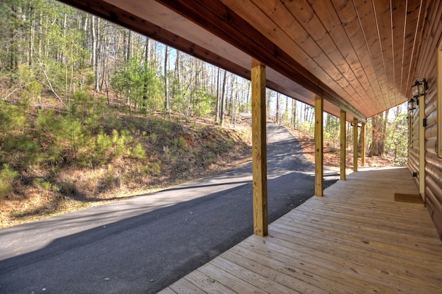 wooden terrace featuring a forest view