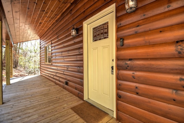 entrance to property featuring faux log siding