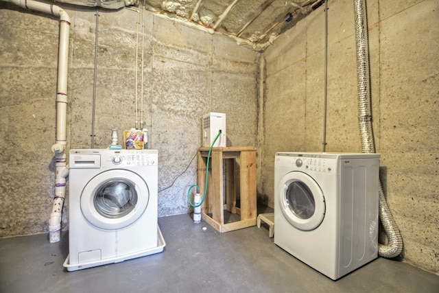 laundry room featuring separate washer and dryer and laundry area