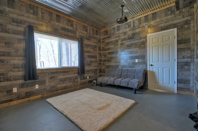 interior space with concrete floors and wood walls