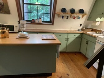 kitchen with light hardwood / wood-style floors, sink, and green cabinets