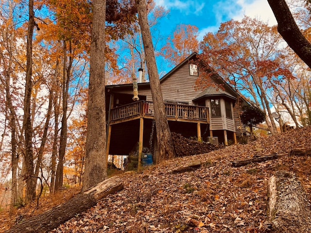 back of property featuring a wooden deck