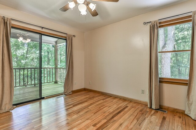 unfurnished room featuring ceiling fan, light hardwood / wood-style flooring, and a wealth of natural light