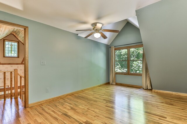 unfurnished room with lofted ceiling, light hardwood / wood-style flooring, and ceiling fan