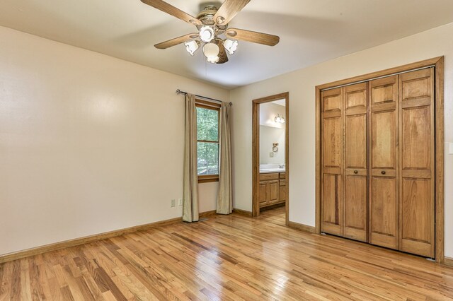 unfurnished bedroom with light hardwood / wood-style floors, connected bathroom, a closet, and ceiling fan