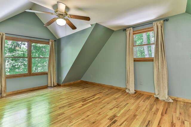 bonus room with vaulted ceiling, light wood-type flooring, and ceiling fan