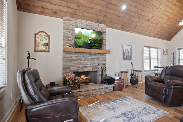 living room featuring lofted ceiling, wooden ceiling, a fireplace, and wood finished floors