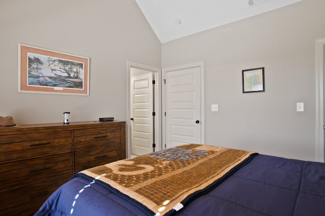 bedroom with lofted ceiling and visible vents