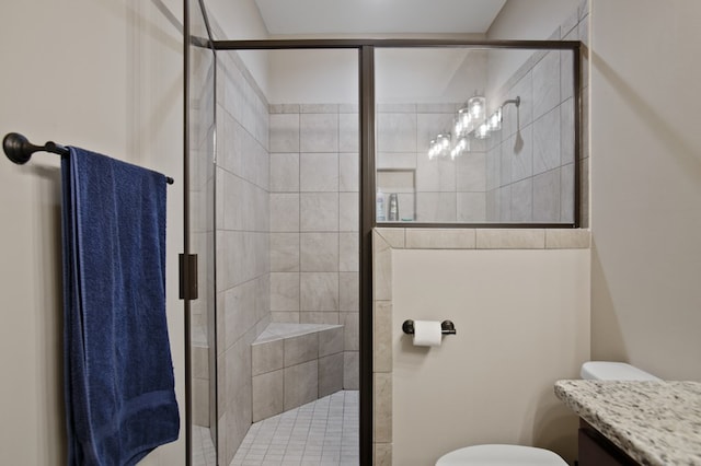 bathroom featuring a stall shower, vanity, and toilet