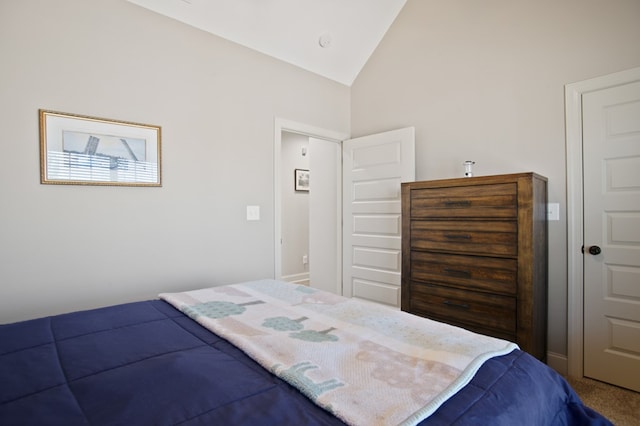 bedroom with vaulted ceiling and carpet flooring