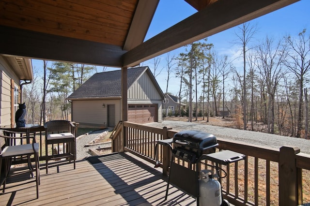 wooden terrace featuring an outdoor structure and a detached garage