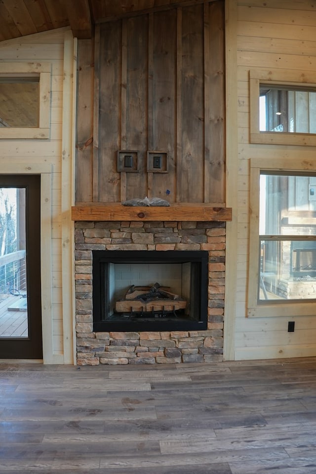 interior details featuring hardwood / wood-style flooring and wood walls