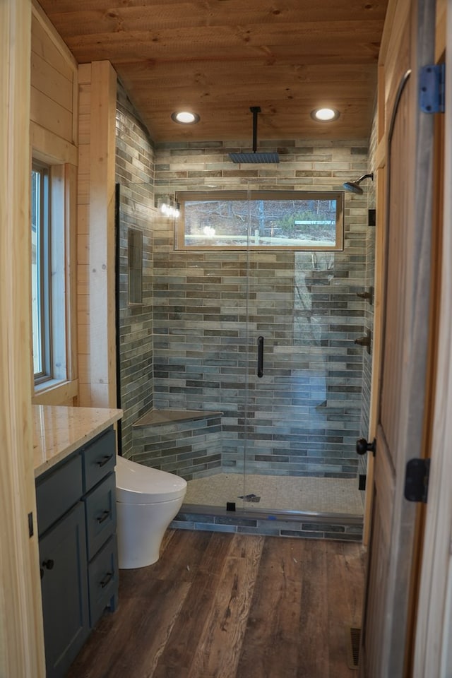 bathroom with toilet, an enclosed shower, wooden ceiling, vanity, and hardwood / wood-style floors