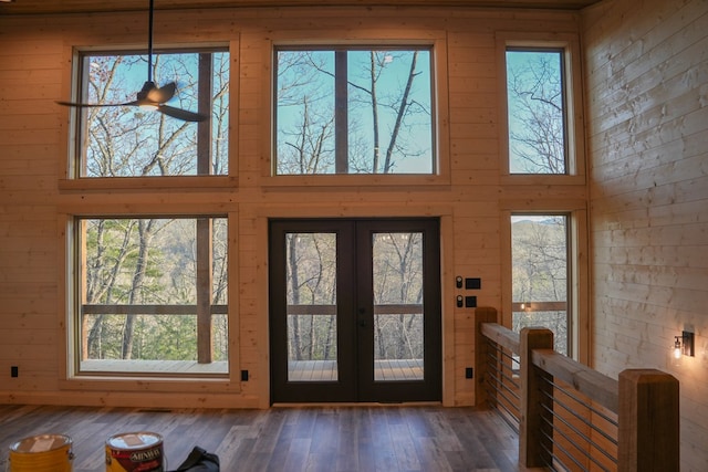 entryway with french doors, dark hardwood / wood-style floors, and a high ceiling