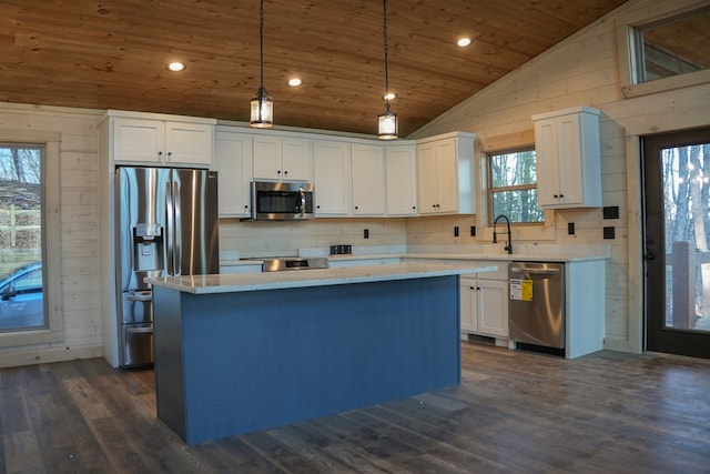 kitchen featuring pendant lighting, stainless steel appliances, a center island, white cabinets, and wooden ceiling