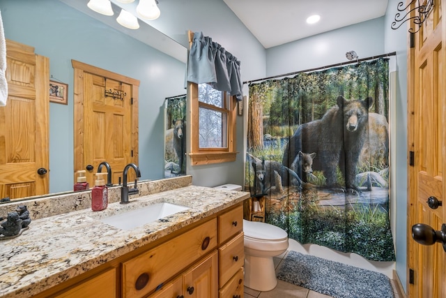 bathroom featuring a shower with shower curtain, tile patterned flooring, vanity, and toilet