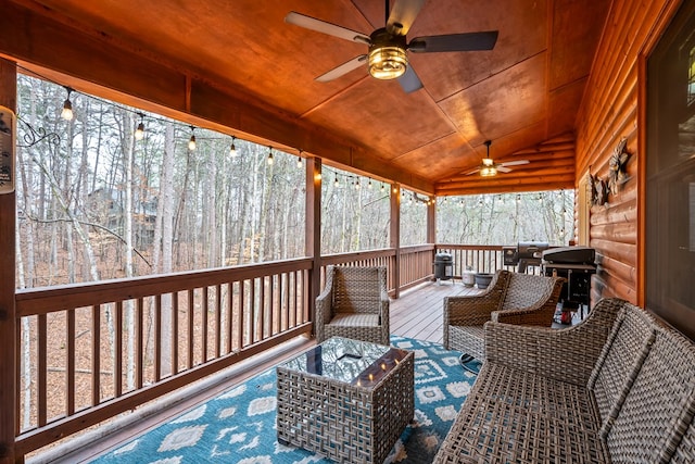 sunroom / solarium with lofted ceiling, ceiling fan, and wood ceiling