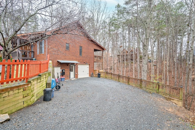 view of home's exterior featuring a garage and a balcony