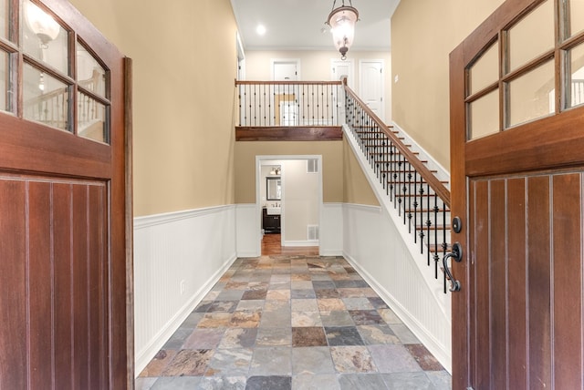 802 Old Mill Trl, Ball Ground, GA 30107 - entryway featuring stairway, dark stone finish floors, wainscoting, crown molding, and baseboards