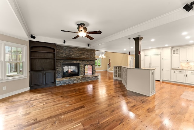 802 Old Mill Trl, Ball Ground, GA 30107 - unfurnished living room with plenty of natural light, crown molding, a ceiling fan, light wood-style flooring, and baseboards