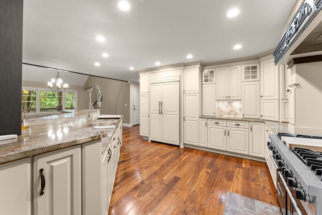 802 Old Mill Trl, Ball Ground, GA 30107 - kitchen with a sink, wood finished floors, white cabinets, tasteful backsplash, and a chandelier