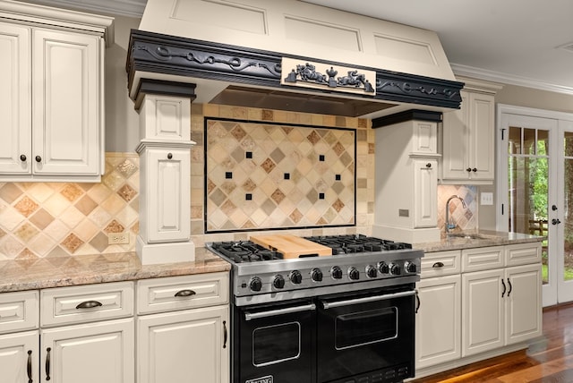 802 Old Mill Trl, Ball Ground, GA 30107 - kitchen with range with two ovens, a sink, premium range hood, crown molding, and decorative backsplash