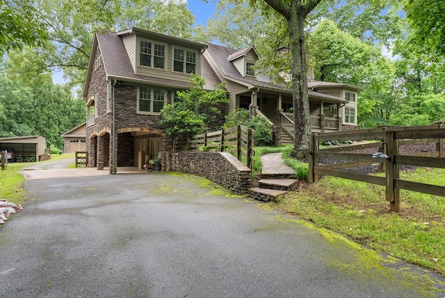 802 Old Mill Trl, Ball Ground, GA 30107 - view of front of property with stone siding, covered porch, a gate, and roof with shingles