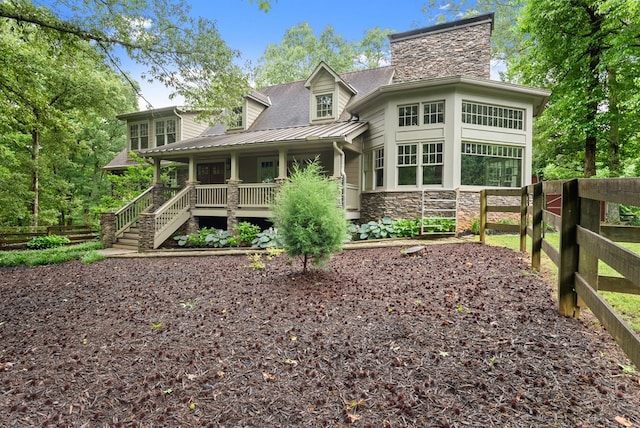 802 Old Mill Trl, Ball Ground, GA 30107 - rear view of house with a porch, stone siding, a standing seam roof, metal roof, and a chimney