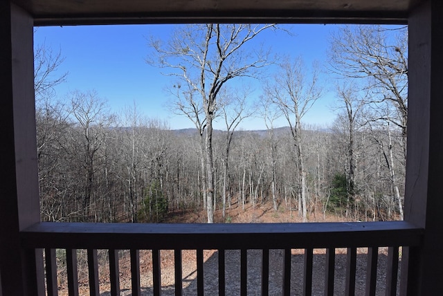 balcony featuring a view of trees