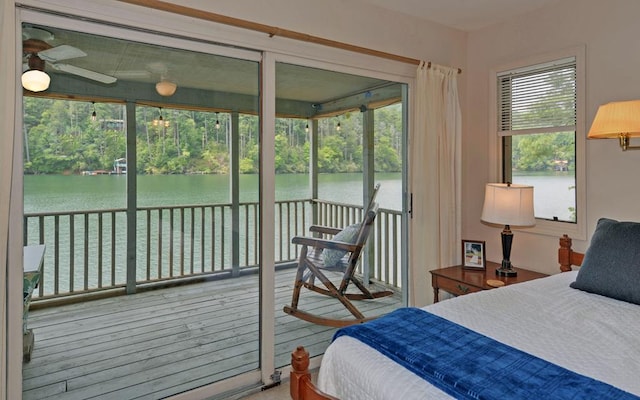 bedroom featuring a water view, ceiling fan, and hardwood / wood-style flooring