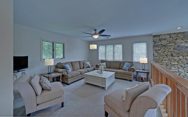 carpeted living room featuring ceiling fan and a wealth of natural light