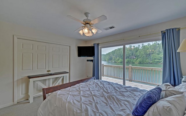 bedroom with carpet flooring, ceiling fan, a closet, and access to exterior