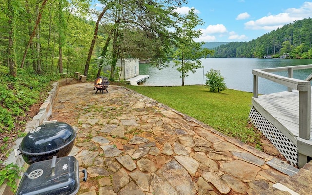 view of patio / terrace with a water view and a fire pit