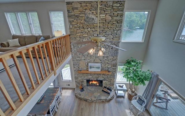 living room with ceiling fan, a fireplace, and hardwood / wood-style floors