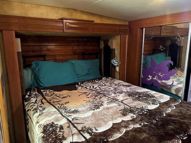 bedroom with lofted ceiling and a closet