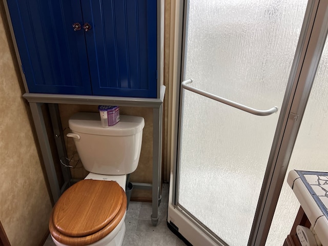 bathroom featuring tile patterned floors and toilet