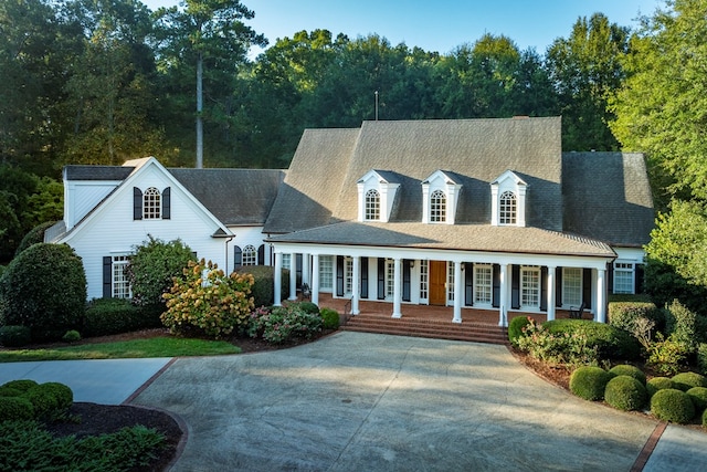 cape cod house featuring a porch