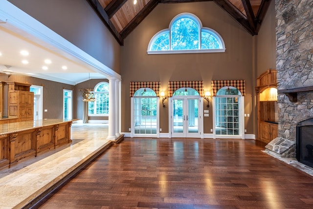 interior space featuring dark hardwood / wood-style flooring, high vaulted ceiling, and a wealth of natural light