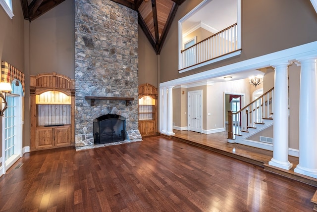 unfurnished living room featuring ornamental molding, high vaulted ceiling, beamed ceiling, a fireplace, and hardwood / wood-style floors