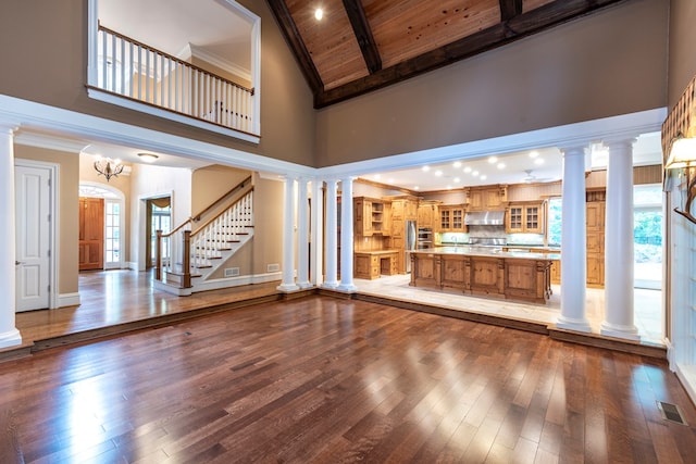 unfurnished living room featuring hardwood / wood-style flooring, high vaulted ceiling, and a wealth of natural light