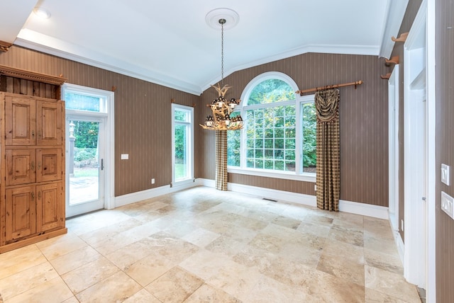 unfurnished dining area with a chandelier, wood walls, crown molding, and vaulted ceiling